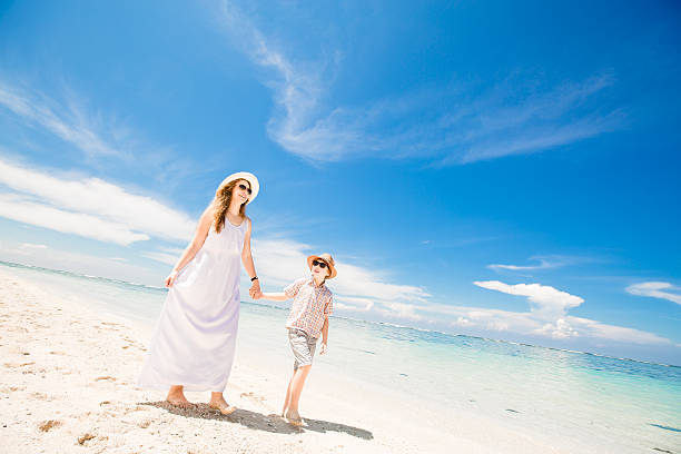 istock Happy beautiful young mother and son enjoying beach time with 472302136