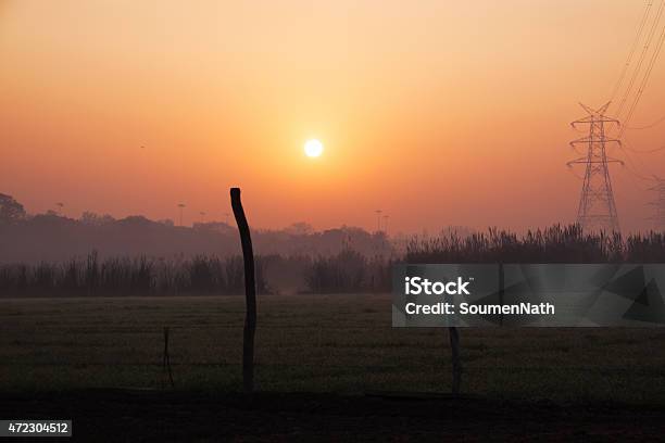 Sunset Over Agricultural Land And A Huge Transmission Line Stock Photo - Download Image Now