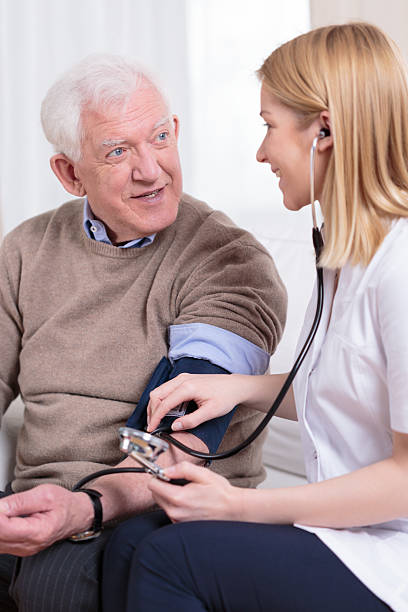 istock Nurse measuring blood pressure 472304590