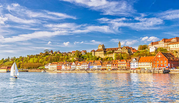 Beautiful spring day in Meersburg at Lake Constance (Bodensee) Panoramic view on the charming medieval city of Meersburg, located at the Lake Constance (Bodensee), with a sailing boat passing the city´s beautiful waterfront in the lower town and it´s landmark castles in the upper town.  baden württemberg stock pictures, royalty-free photos & images