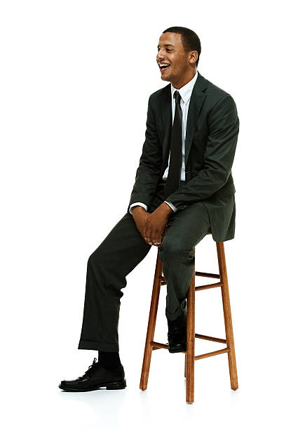 istock Smiling businessman on stool and looking away 472306558