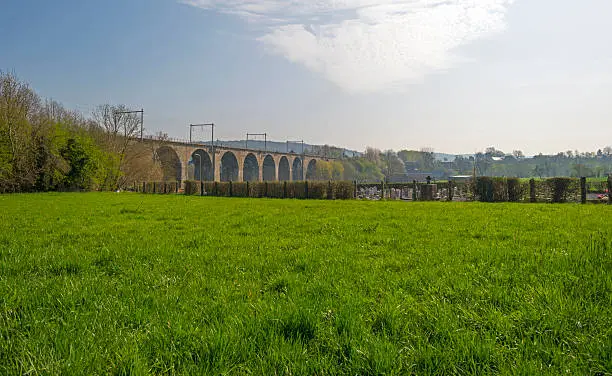 Photo of Viaduct along a cemetary in a green field