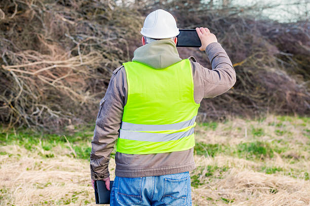 istock Forest engineer with tablet PC near pile of twigs 472310102