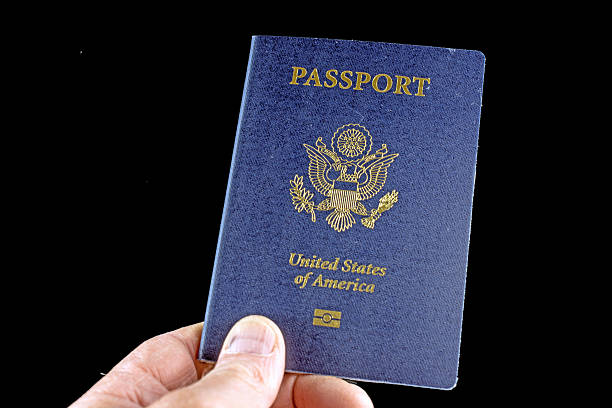 istock United States passport hand held on black 472310138
