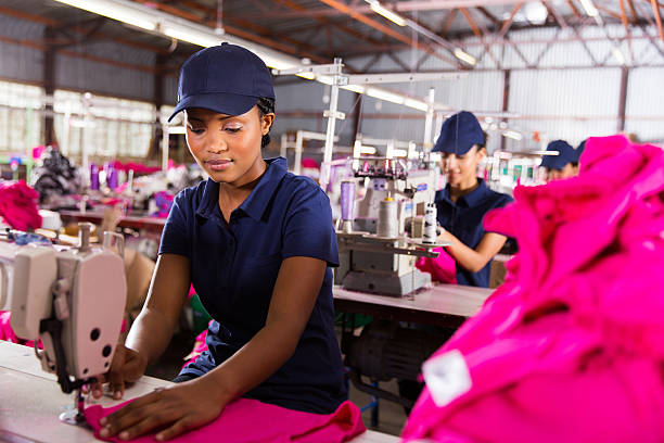 istock female factory worker sewing 472310936