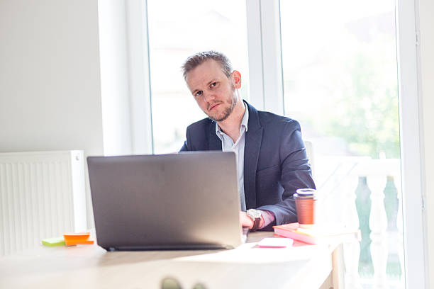 istock Hard work for a businessman sitting on his desk 472311032