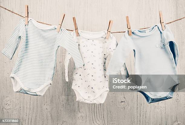 Baby Clothes Hanging On The Clothesline Stock Photo - Download Image Now - Baby - Human Age, Clothing, Infant Bodysuit