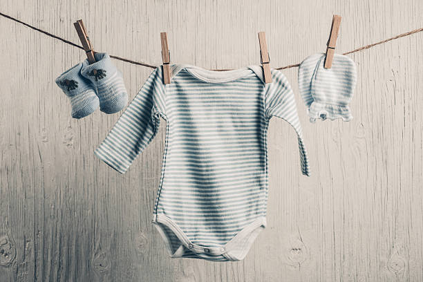 istock Baby clothes hanging on the clothesline 472311862
