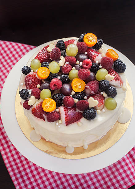 istock White chocolate cake decorated with fresh berries and fruits 472311976