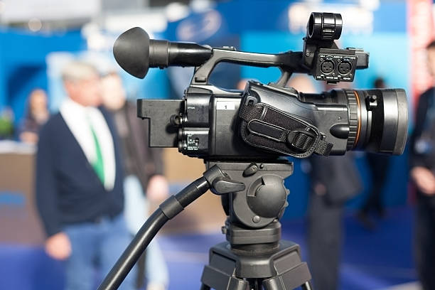 istock Video camera on tripod mount ready to film an event 472314626