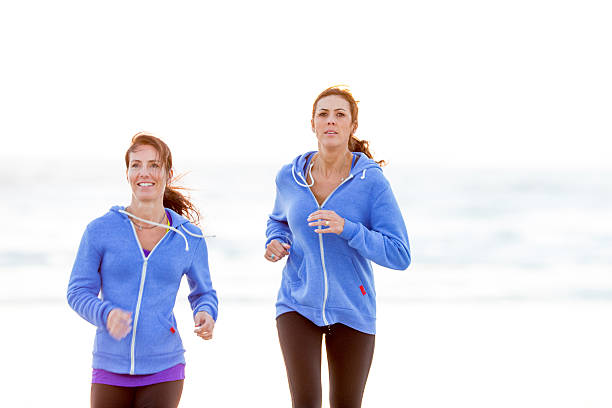 istock Woman running on the beach 472314722