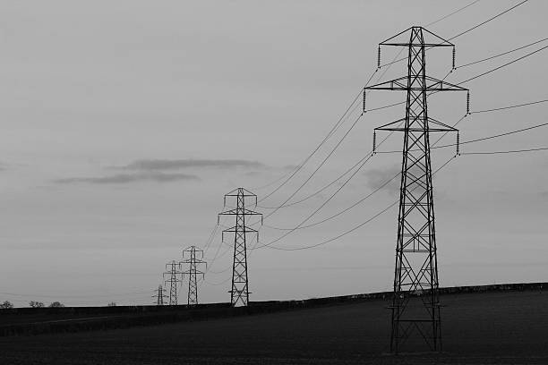 istock Electricity pylons across agricultural landscape 472315066
