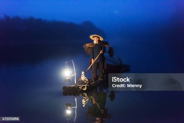 Chinese Old Senior Fisherman On Wooden Raft Fishing Li River Stock Photo - Download Image Now