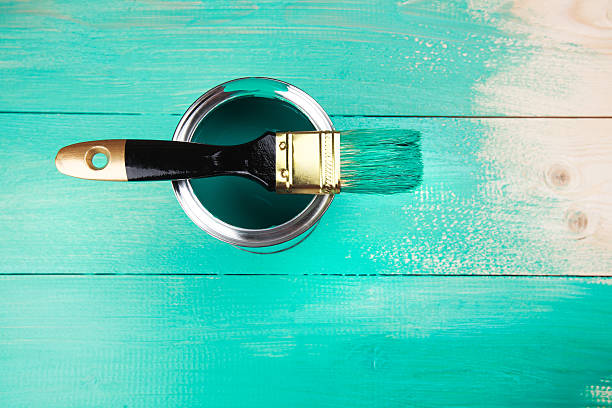 istock Varnishing a wooden shelf using paintbrush 472316762
