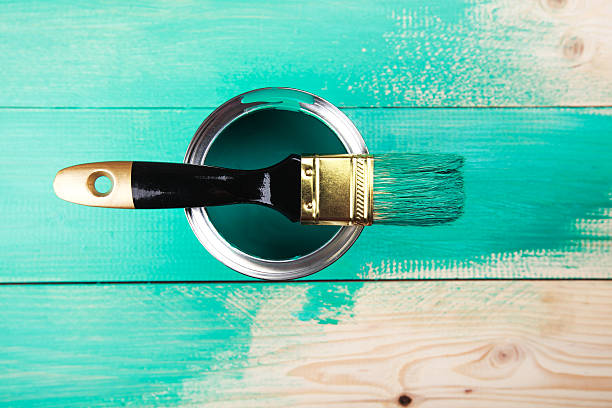 istock Varnishing a wooden shelf using paintbrush 472316768