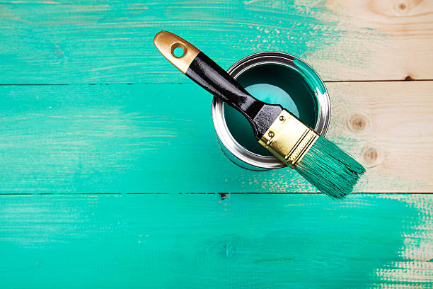 istock Varnishing a wooden shelf using paintbrush 472316810