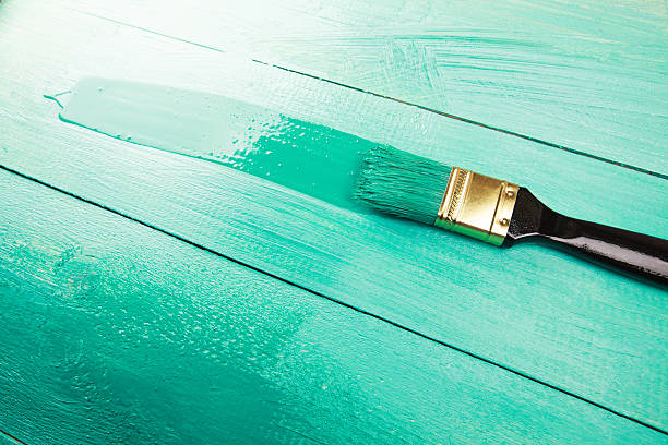 istock Varnishing a wooden shelf using paintbrush 472316856