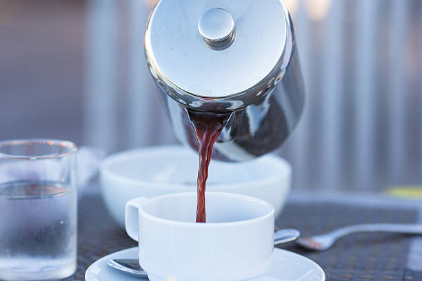 istock Closeup of teapot and coffee in a white cup 472317154