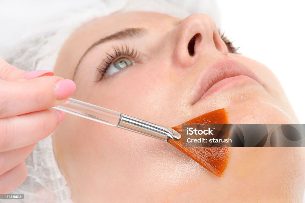 facial peeling mask applying beauty salon, facial peeling mask with retinol and fruit acids Peel - Plant Part Stock Photo