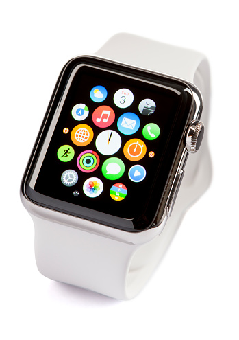 Belen, New Mexico, USA - May 3, 2015: A 38mm stainless steel Apple Watch with white sports band. The Apple Watch became available April 24, 2015, bringing a new way to receive information at a glance, using apps designed specifically for the wrist.