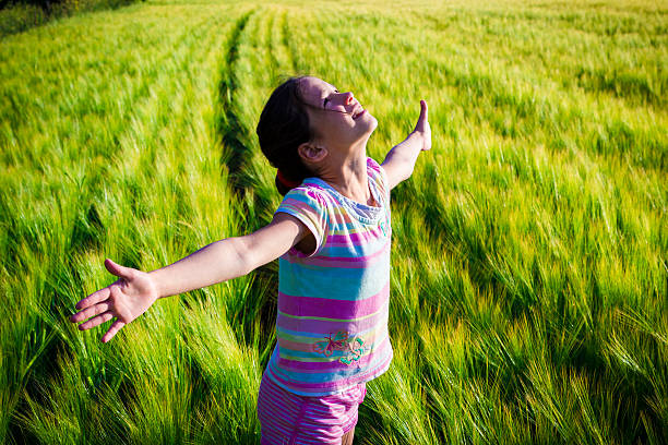 istock Happy girl on wheat field 472327532