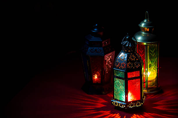 istock 3 Ramadan lanterns illuminated with color glass on black 472328892