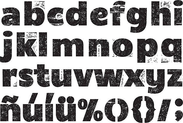 Black and white rubber stamp alphabet Lower case rubber stamp alphabet set with foreign and other characters. stamped texture stock illustrations