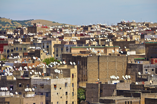 Ancient rooftops of Fez medina with modern satellite dishes