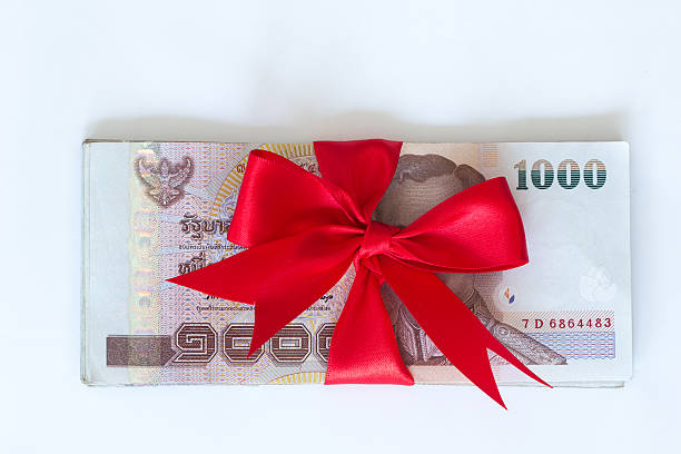 istock Thailand money banknotes with red ribbon 472330932