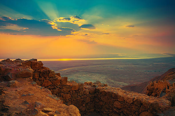 istock Beautiful sun rising over Masada fortress 472331472