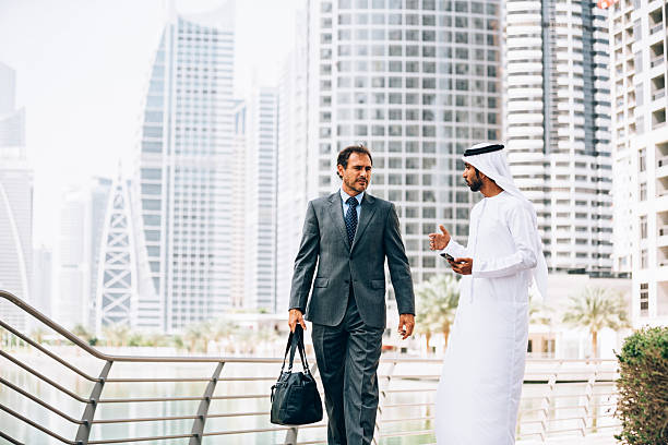 istock Emirati man having outdoors business meeting 472335968