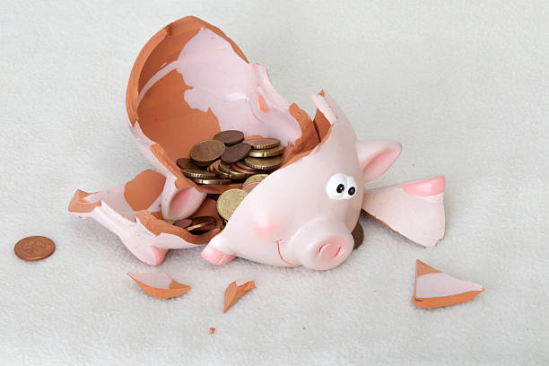 istock Shattered piggybank with coins 472336172