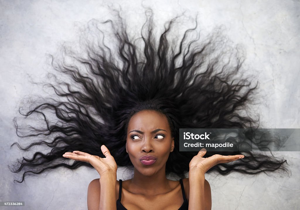 Woman With Big Messy Hair And Wondering Expression Stock Photo
