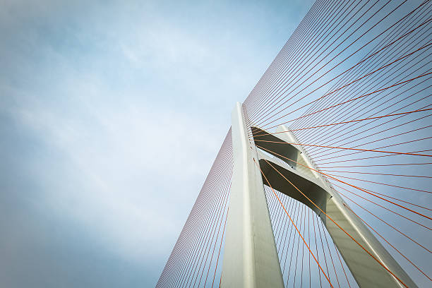 cable-stayed bridge closeup cable-stayed bridge closeup against a cloudy sky suspension bridge stock pictures, royalty-free photos & images