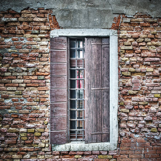 istock old window in a brick wall in Venice 472339348