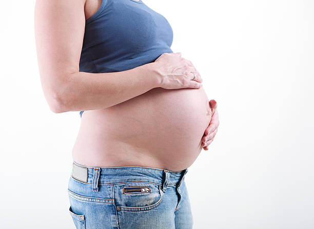 istock Baby belly against white background 472342424