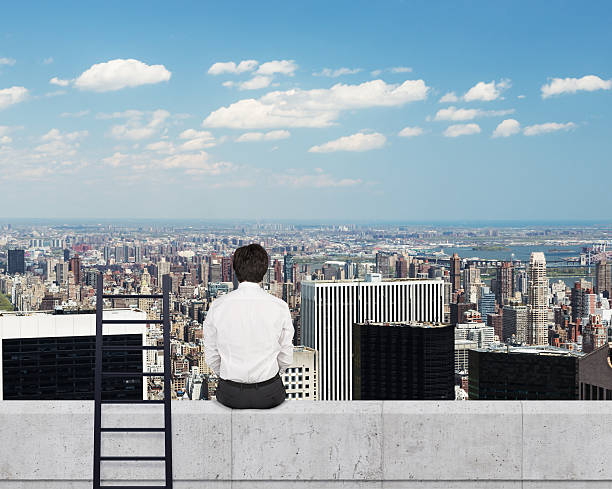 istock businessman looking to city 472342430