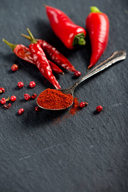 istock Vibrant red mexican hot chilli pepper, whole and grounded 472342694