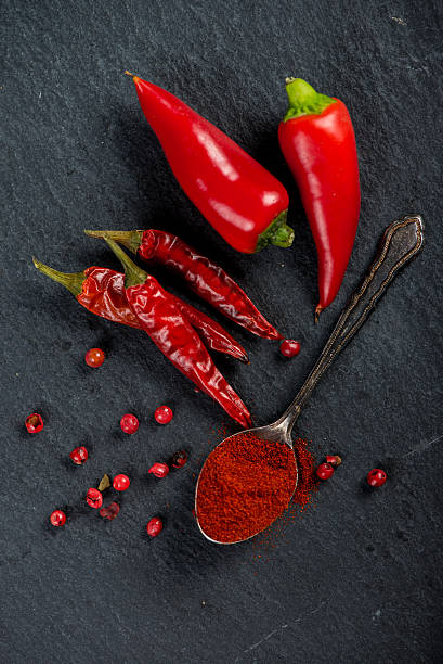 istock Vibrant red mexican hot chilli pepper, whole and grounded 472342696