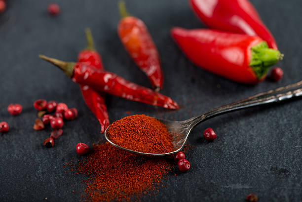istock Vibrant red mexican hot chilli pepper, whole and grounded 472342702