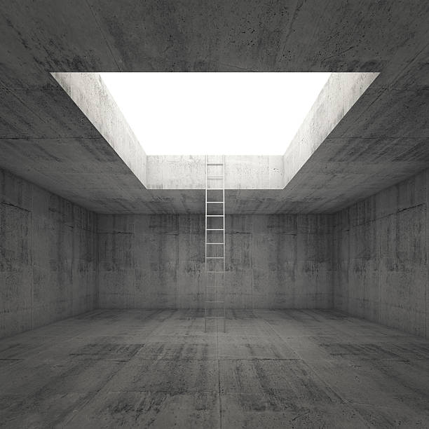 istock Ladder goes to the light out from dark concrete interior 472342778
