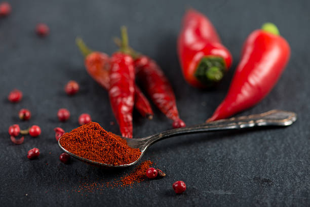 istock Vibrant red mexican hot chilli pepper, whole and grounded 472343336