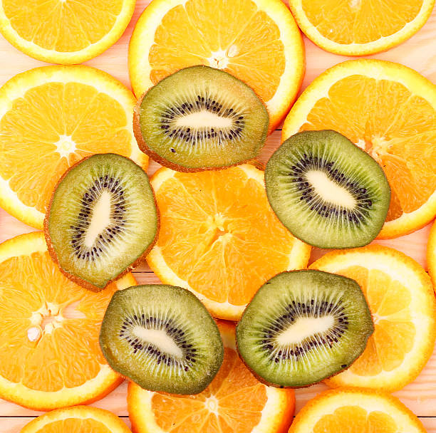istock Oranges, kiwi on a wooden surface (seen from above) 472345792