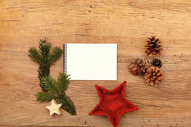 istock Notepad, fir twig and cones on wood 472345808