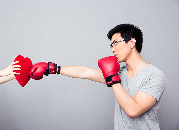 istock Concept image of a man in boxing gloves 472349344
