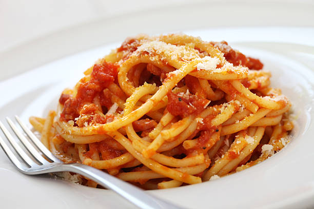 amatriciana, italian tomato sauce pasta bucatini alla amatriciana, italian tomato sauce pasta all'amatriciana stock pictures, royalty-free photos & images