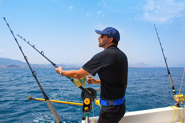 Blue Sea Fisherman In Trolling Boat With Downrigger Stock Photo - Download  Image Now - iStock
