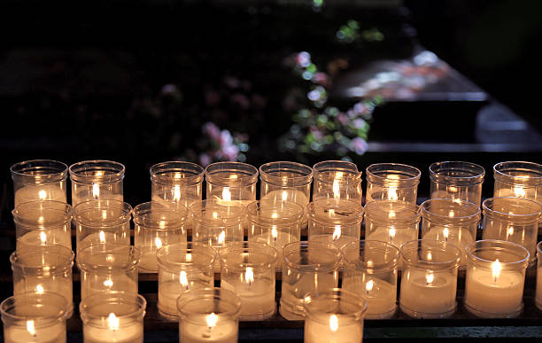 istock lit candles to pray inside a church 472354656