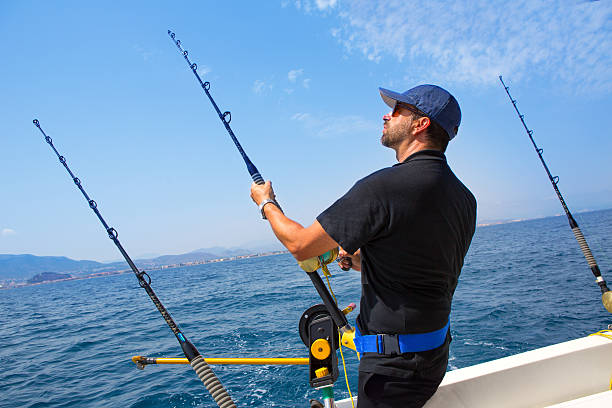 istock A blue sea fisherman in a boat with a downrigger 472354716