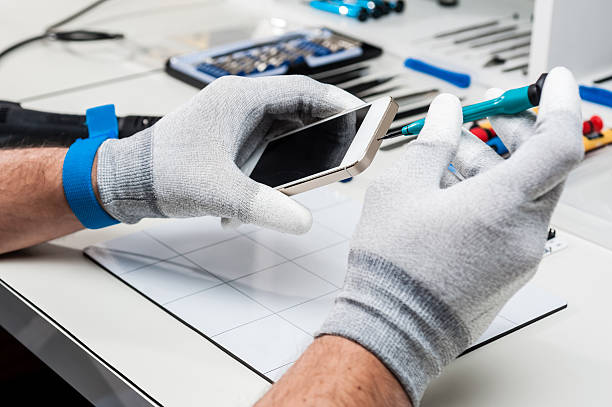 Technician repairing a smarphone Technician replacing the screen of a used smartphone phone repair stock pictures, royalty-free photos & images